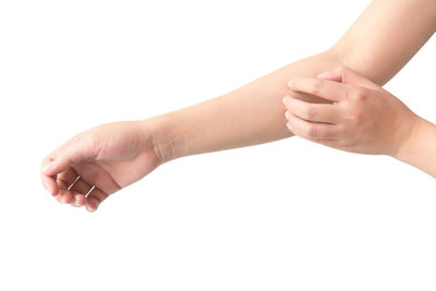 Close-up of hands over white background