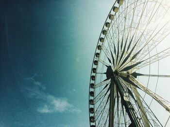 Low angle view of ferris wheel against sky