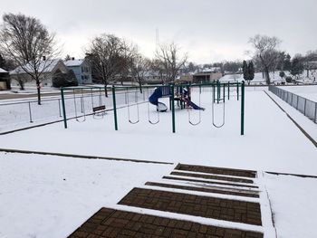 View of playground against snow covered trees