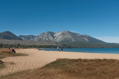 Scenic view of beach against clear blue sky