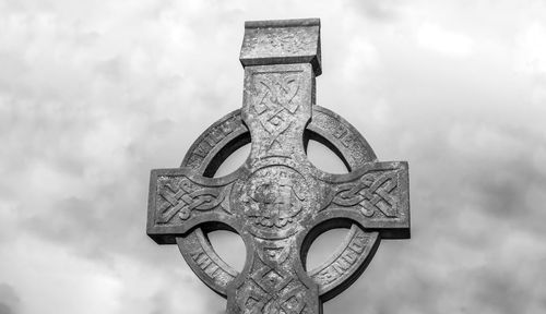 Low angle view of cross against sky