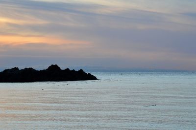 Scenic view of sea against sky at sunset