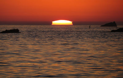 Scenic view of sea against orange sky