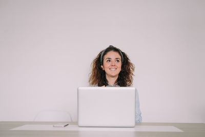 Portrait of smiling girl sitting on table