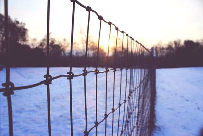 View of fence at sunset