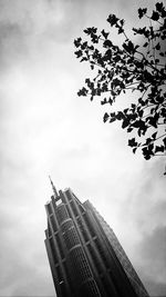 Low angle view of building against cloudy sky