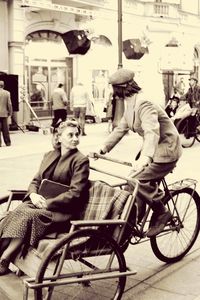 People sitting on street in city