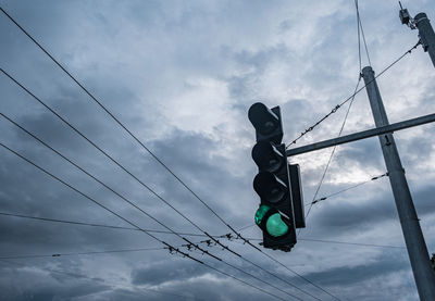 Low angle view of traffic signal against sky