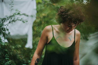 Close-up of woman standing against trees