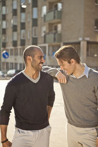 Front view of mid adult male friends enjoying together outdoors