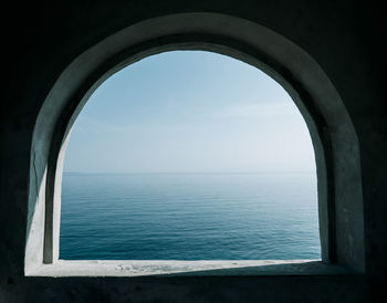 Minimalsit photo of a window overlooking the sea.