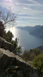 Scenic view of sea and mountains against sky