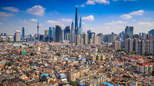 Cityscape against cloudy sky