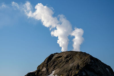 Low angle view of mountain against blue sky