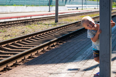 Full length of boy standing on railroad track