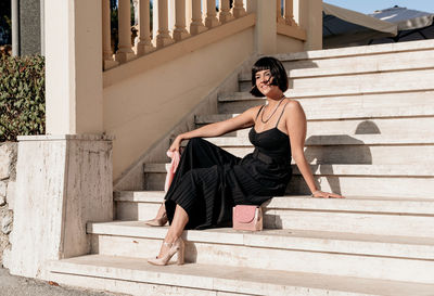 Portrait of beautiful young woman waring elegant black jumpsuit