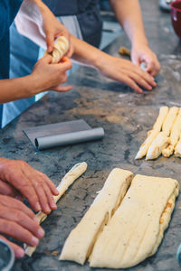 Cropped hand making cinnamon rolls