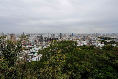 High angle view of trees and buildings against sky