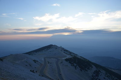 Scenic view of snowcapped mountains against sky during sunset