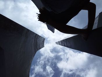 Low angle view of silhouette buildings against sky