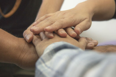 Close-up of friends stacking hands