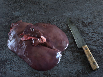 High angle view of meat in plate on cutting board