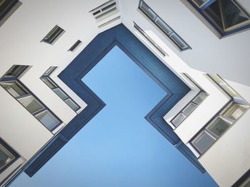 Fassade and roof of modernist building against blue sky