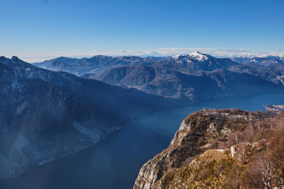 Scenic view of snowcapped mountains against blue sky