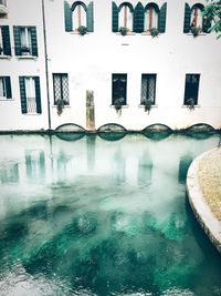 Reflection of buildings in swimming pool