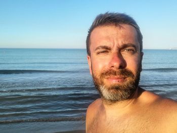 Portrait of man in sea against clear sky