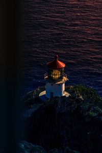 High angle view of lighthouse by sea against sky