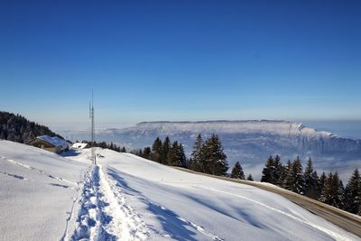 Snow covered mountain against blue sky