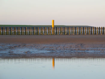 Scenic view of beach against sky during sunset