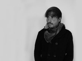 Portrait of man smoking against white background