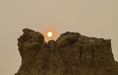 Low angle view of rock formation against sky