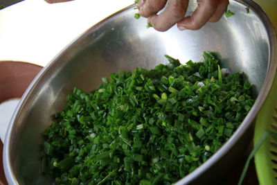 Close-up of person preparing food in bowl