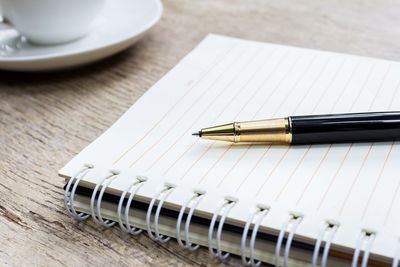 High angle view of pen on book at table