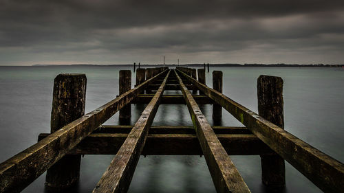 Pier over sea against sky