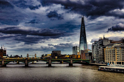 View of bridge over river against cloudy sky