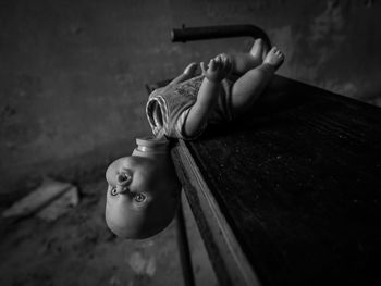 Close-up of baby boy with toy on wood