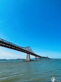 View of bridge over sea against clear sky