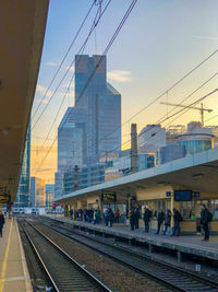 Railroad station in city against sky