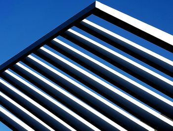 Low angle view of built structure against blue sky on sunny day