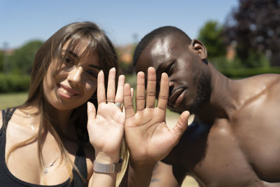 Black man and white woman holding hands