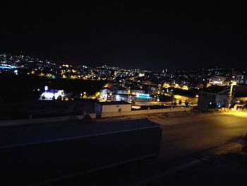 High angle view of illuminated buildings against sky at night