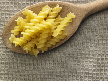 Close-up of fusilli pasta on wooden spoon