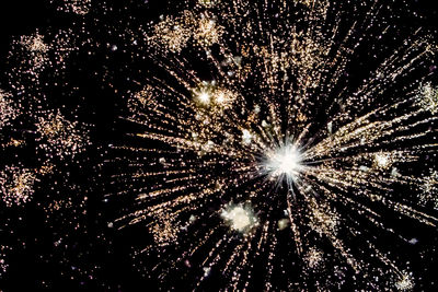 Low angle view of firework display at night