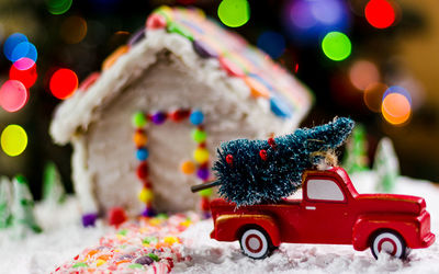 Close-up of gingerbread house with christmas decorations at home