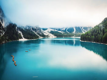 Scenic view of lake and mountains against sky