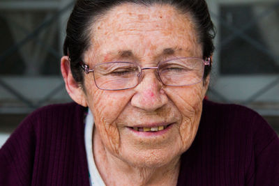 Close-up of smiling senior woman with eyes closed